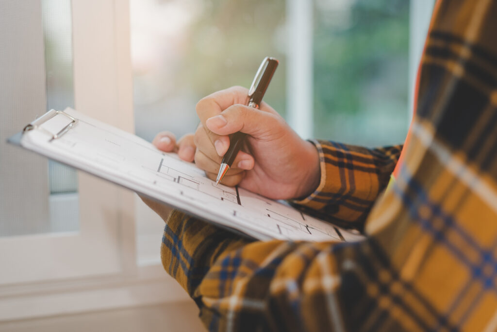 Building inspection, asian contractor young man, male inspecting home, reconstructed construction, renovation or check defect, before finish handing it over to client, customer. Engineering worker. university student moving checklist